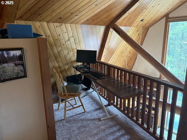 office area with wood ceiling, wooden walls, and vaulted ceiling