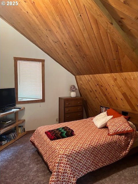 carpeted bedroom with wood ceiling and vaulted ceiling