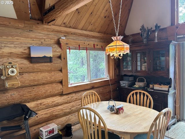 dining area with high vaulted ceiling