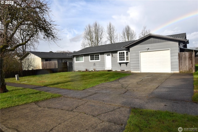 ranch-style house with an attached garage, driveway, fence, and a front lawn