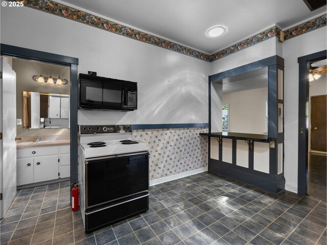 682 S Settlemier Ave, Woodburn, OR 97071 - kitchen featuring black microwave, electric stove, white cabinetry, wallpapered walls, and dark tile patterned flooring