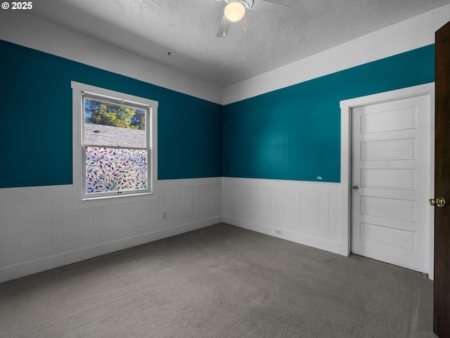 682 S Settlemier Ave, Woodburn, OR 97071 - carpeted spare room with a wainscoted wall, ceiling fan, and a textured ceiling