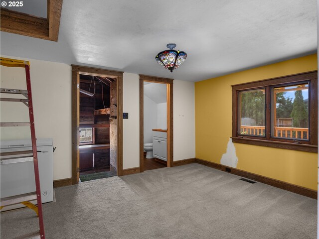 682 S Settlemier Ave, Woodburn, OR 97071 - unfurnished bedroom with carpet flooring, baseboards, and connected bathroom