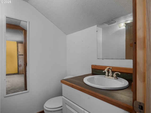 682 S Settlemier Ave, Woodburn, OR 97071 - bathroom with a textured ceiling, vanity, toilet, and vaulted ceiling