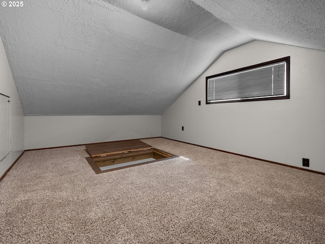 682 S Settlemier Ave, Woodburn, OR 97071 - additional living space featuring a textured ceiling, vaulted ceiling, carpet flooring, and baseboards