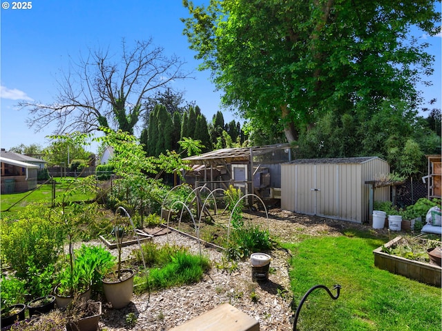 682 S Settlemier Ave, Woodburn, OR 97071 - view of yard featuring a garden, a storage shed, and an outdoor structure