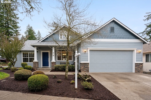 craftsman-style house with stone siding, driveway, and a garage