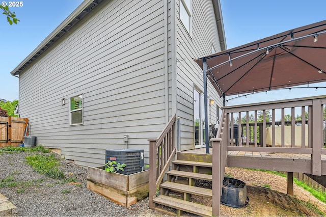 1225 NE Rockwell Dr, Estacada, OR 97023 - view of side of home featuring central AC unit, a wooden deck, and a gazebo
