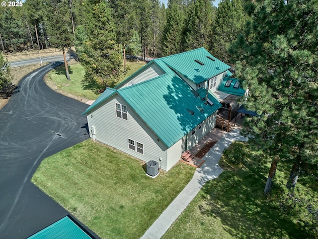 aerial view of property and surrounding area with a heavily wooded area