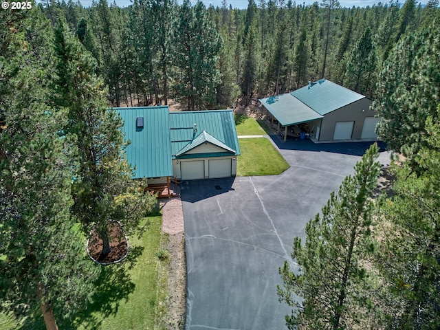 aerial view of property and surrounding area with a forest