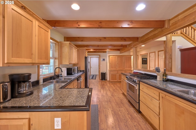 kitchen featuring stainless steel appliances, light brown cabinets, a sink, beam ceiling, and recessed lighting