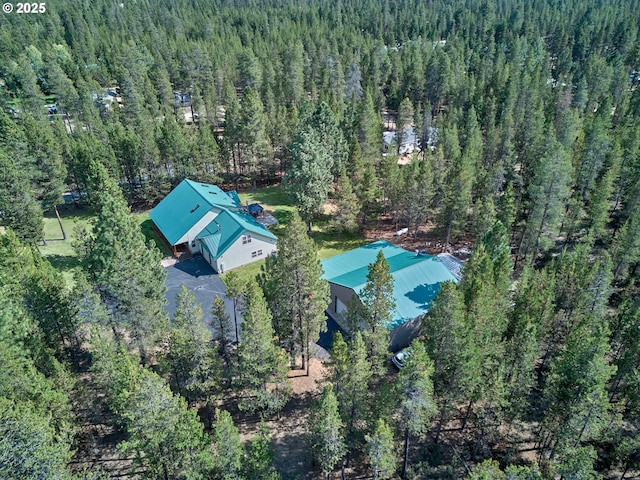 view from above of property with a heavily wooded area
