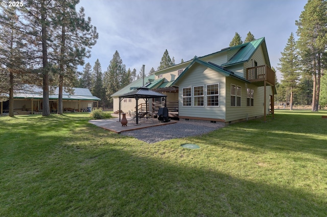 back of property featuring a gazebo, crawl space, a yard, and a patio