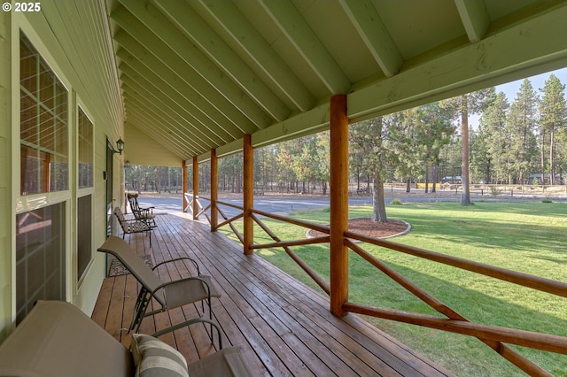 wooden terrace featuring a lawn