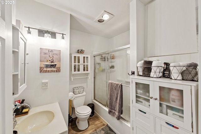 2745 34th St, Coos Bay, OR 97420 - full bath featuring toilet, wood finished floors, enclosed tub / shower combo, and vanity