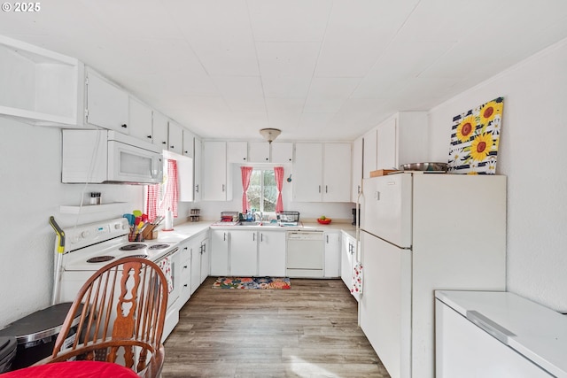 2745 34th St, Coos Bay, OR 97420 - kitchen with white appliances, wood finished floors, light countertops, white cabinets, and a sink
