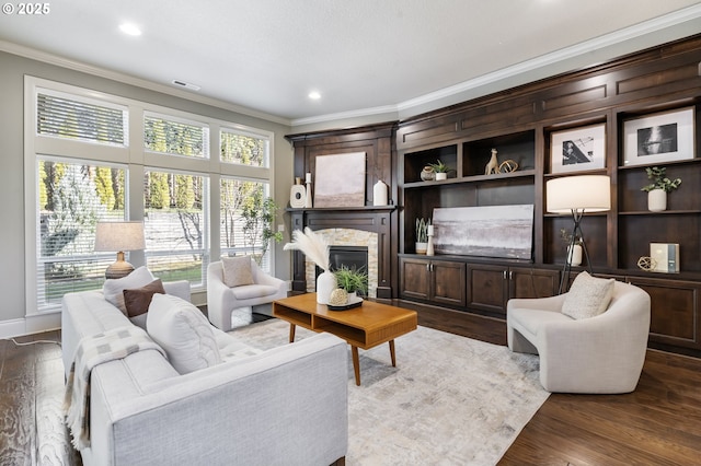 living area featuring dark wood-style floors, a fireplace, and ornamental molding