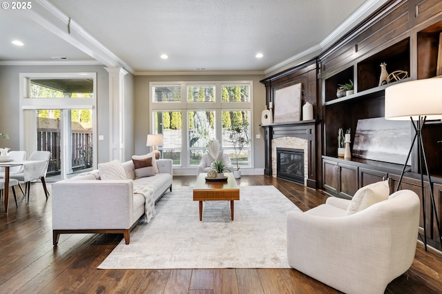 living room with dark wood-style flooring, a fireplace, and plenty of natural light