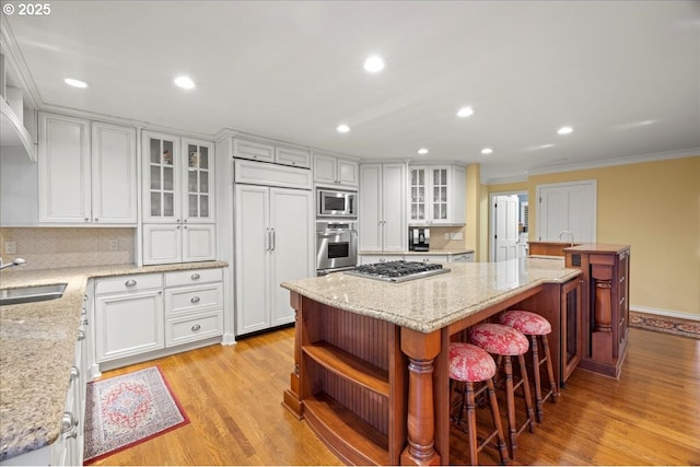 kitchen with white cabinetry, open shelves, and built in appliances