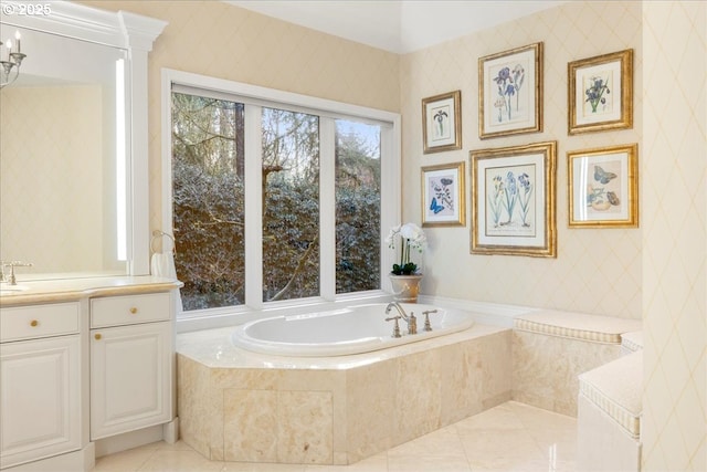 bathroom with tile patterned floors, vanity, and a relaxing tiled tub