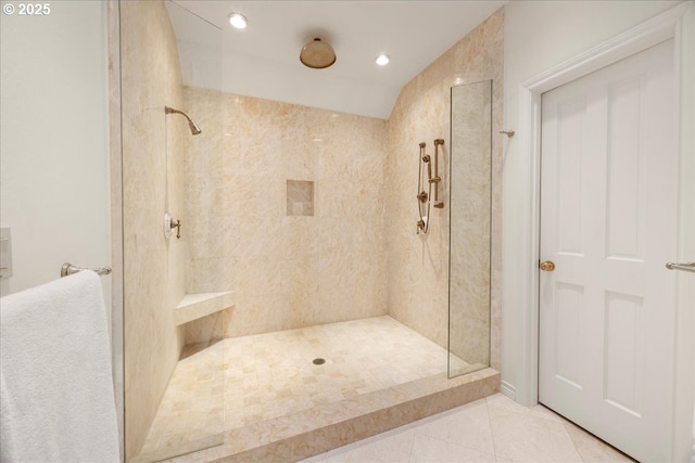 bathroom featuring a tile shower and tile patterned floors