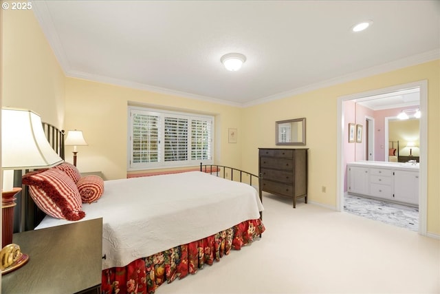 carpeted bedroom with ensuite bathroom and ornamental molding