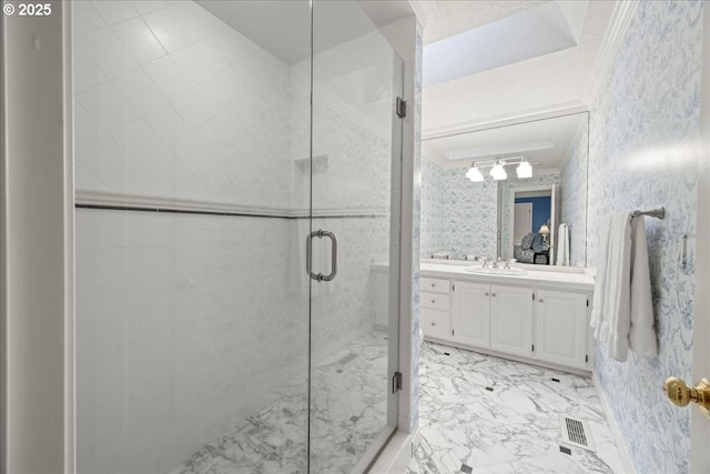 bathroom with crown molding, vanity, and an enclosed shower