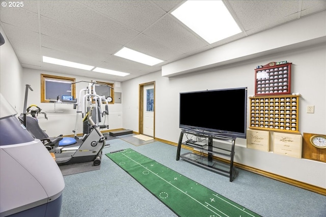 interior space featuring carpet flooring and a drop ceiling