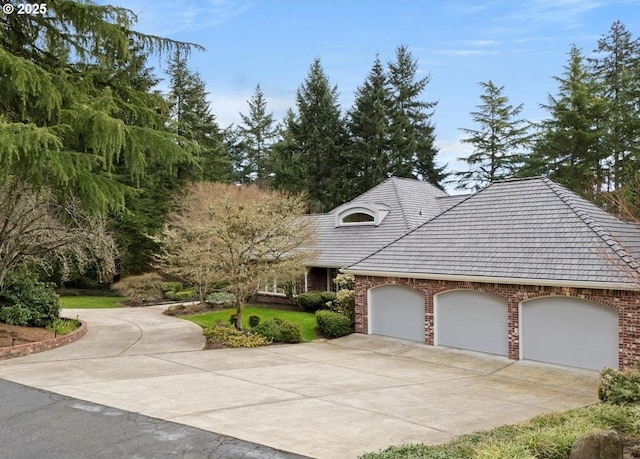 view of front of home with brick siding, concrete driveway, and a garage