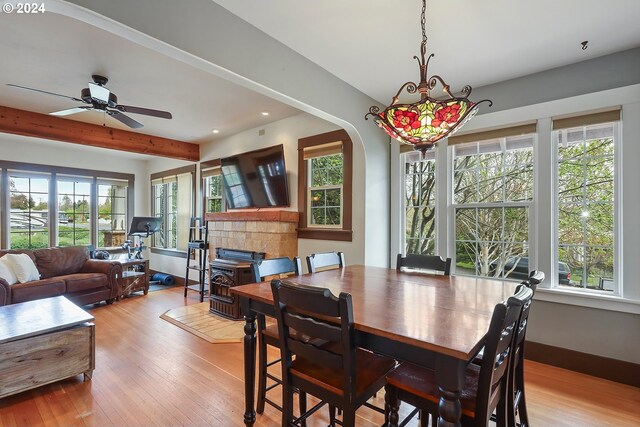 dining space with beamed ceiling, ceiling fan, and light hardwood / wood-style floors