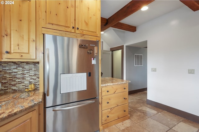 kitchen with stainless steel fridge, beam ceiling, decorative backsplash, and light brown cabinets