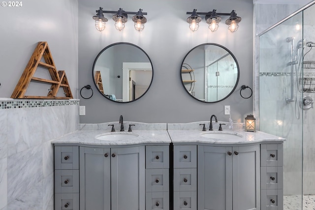 bathroom with vanity and a tile shower