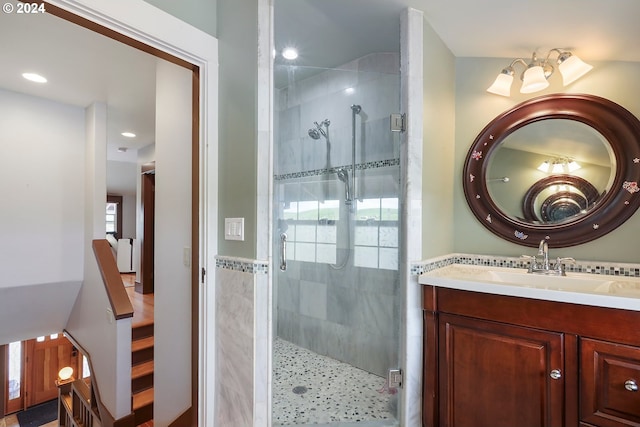 bathroom featuring vanity and a shower with shower door