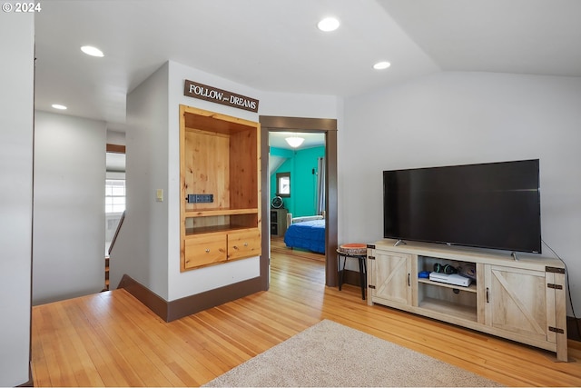 living room with lofted ceiling and hardwood / wood-style floors