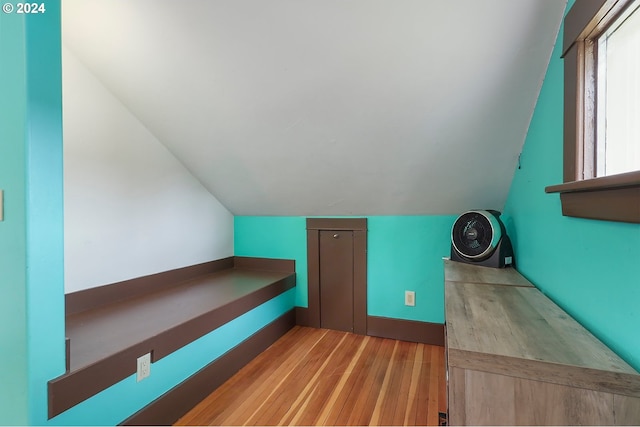 bonus room with vaulted ceiling and light hardwood / wood-style flooring