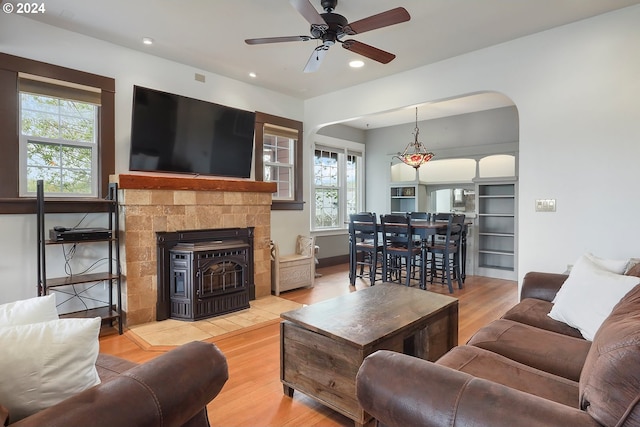 living room with ceiling fan and light wood-type flooring