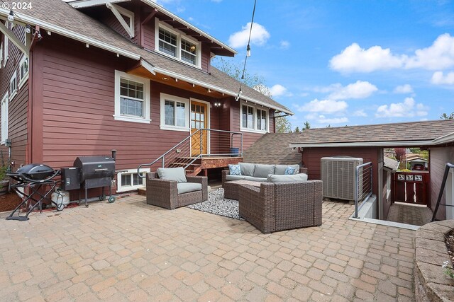 exterior space with a patio, outdoor lounge area, and central air condition unit