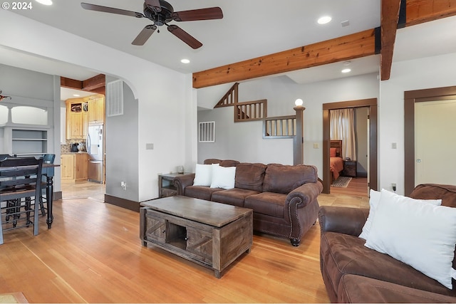 living room featuring ceiling fan, beam ceiling, and light hardwood / wood-style floors