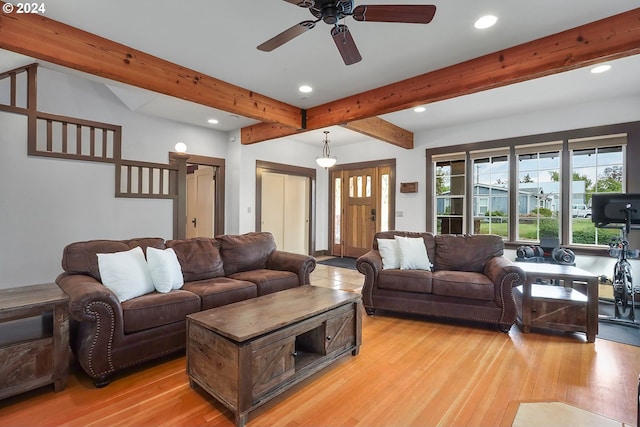 living room featuring ceiling fan, beam ceiling, and light hardwood / wood-style floors