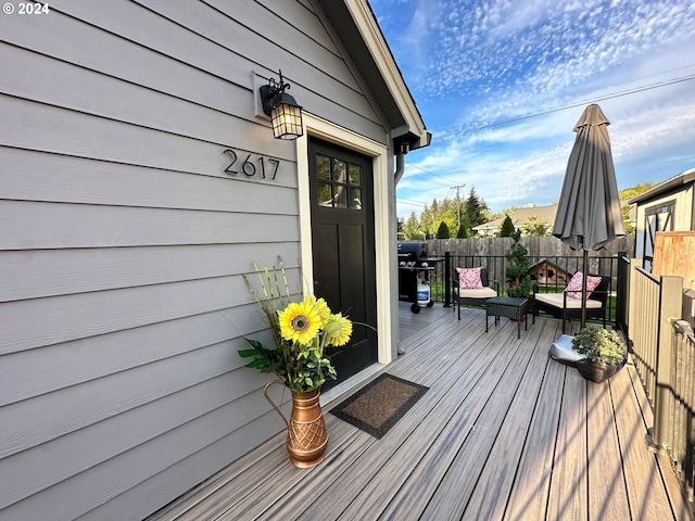 wooden terrace with a grill