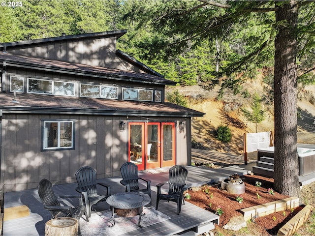 back of house featuring french doors and a deck