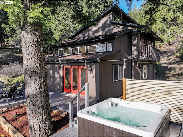 wooden terrace with a hot tub