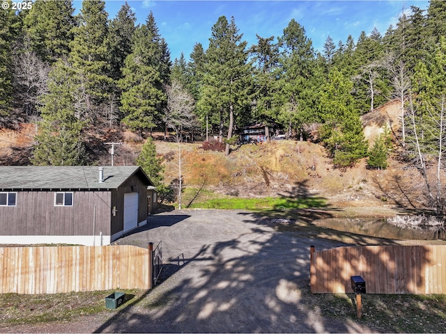 view of yard featuring a garage and fence