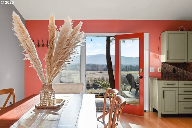 dining space with a mountain view and light wood finished floors