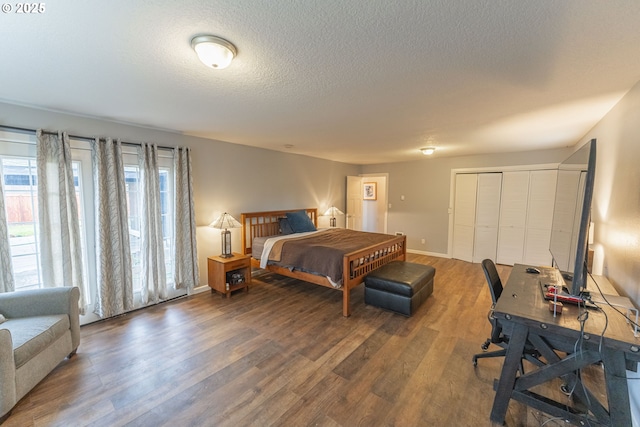 bedroom featuring dark hardwood / wood-style flooring, a closet, and a textured ceiling