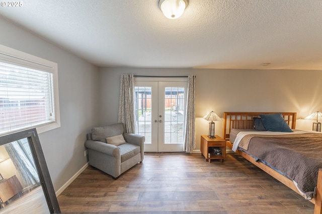 bedroom with french doors, access to exterior, dark wood-type flooring, and a textured ceiling