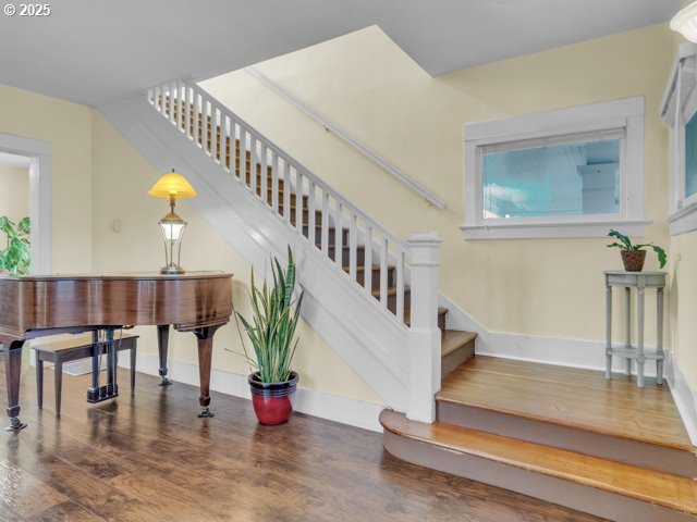 stairway with wood finished floors and baseboards