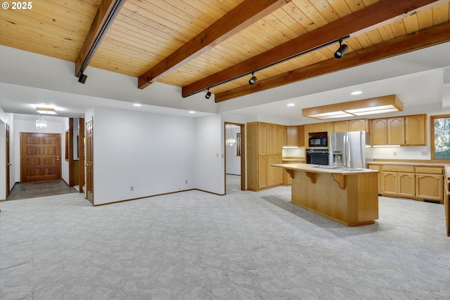kitchen featuring black appliances, wood ceiling, rail lighting, light colored carpet, and light countertops