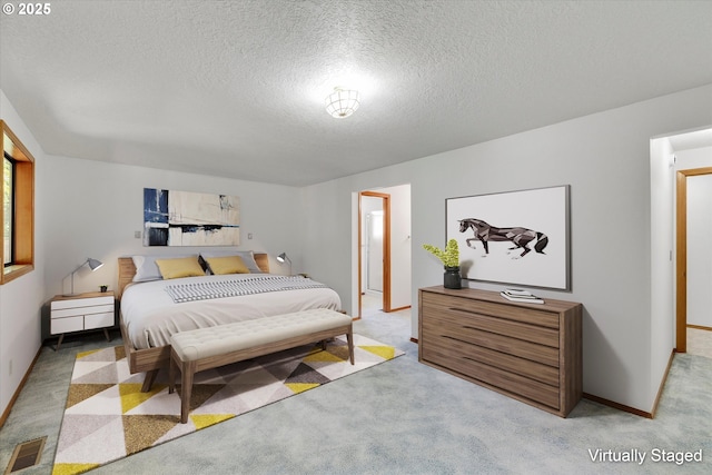 bedroom with carpet flooring, a textured ceiling, and baseboards