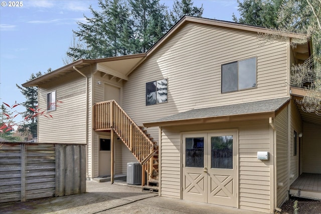 back of property featuring fence, central AC unit, and a patio area
